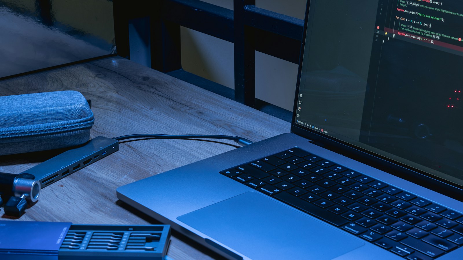 Laptop displaying website development code on a desk