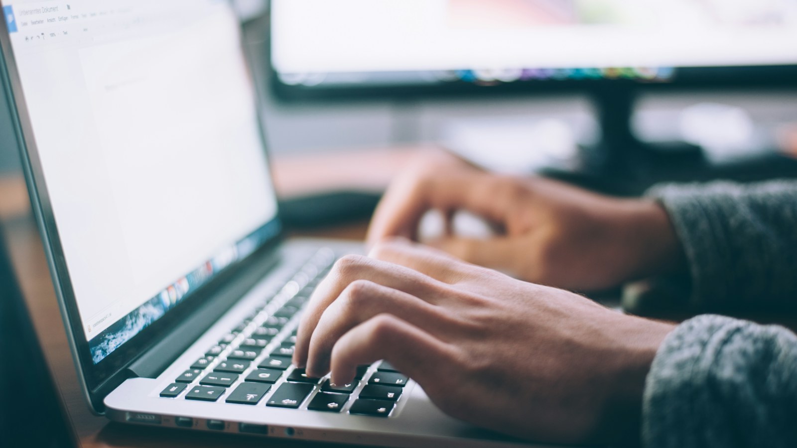 Person planning website work at a laptop with notes